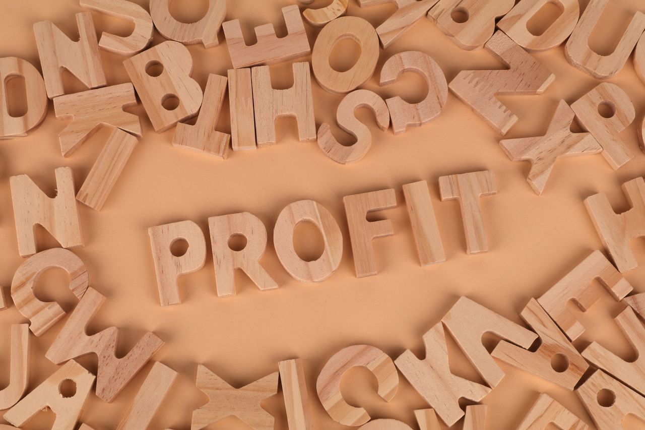 Mastering the First Impression: Your intriguing post title goes here Wooden letters scattered on a table with 'PROFIT' prominently displayed.